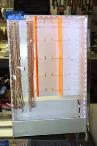 lot 147 image: Gold tone necklaces with lighted display case