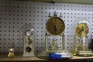 lot 94 image: Two Rotating spin clocks and mini brass clock holder