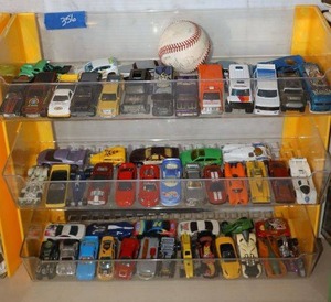 lot 356 image: Toy cars with display unit and baseball. Includes cars from England.