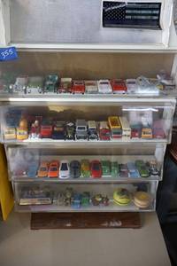 lot 355 image: Toy cars with display unit. Includes cars from England.