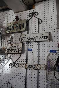 lot 399 image: Vintage license plates with wire holders