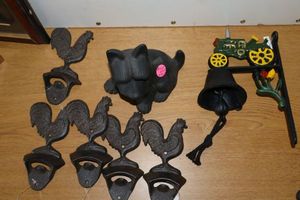 lot 478 image: Cast iron decorations Tractor bell, rooster bottle openers, and dog