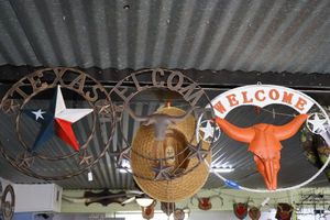 lot 494 image: Metal signs Longhorns colors, Texas color star, and Welcome cattle head sign