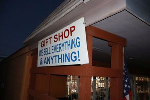 lot 628 image: Metal store sign - must bring tools and step ladder to remove