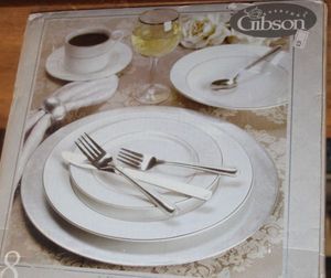 lot 65 image: Gibson, Four Place Setting Dishes in Orginal Box, All Pieces seem to be included, Except Stemware. Set Includes Silver Colored Charger Plates.