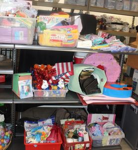 lot 145 image: Three shelves of party related Items, including, napkins, plates, balloons, streamers, piata ballon weights ribbons, goodie bags. Some items never opened
