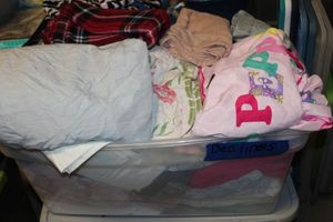 lot 56 image: Tote of linens, Sheets, blankets and more (tote not included)