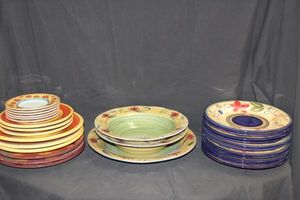 lot 13 image: Dishes HD Designs Simone Hand painted dishes, approx 22 pcs. Pier 1 Elizabeth 3pcs. Mikasa Acapulco small plates, approximately 6. Terre Provence pottery, 6pcs. Pfaltzgraff Evening Sun, 3 plates.