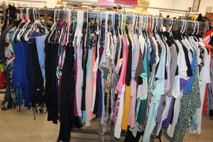 lot 15 image: Entire Rack of Womens Blouses and Scrubs. See photos for more details (clothing rack not included)