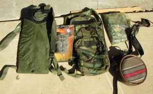 lot 68 image: army green water backpack, poncho, and more