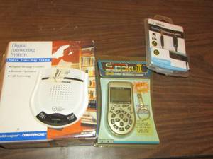 lot 202 image: grid Sudoku game, stereo extension cable, digital answering machine