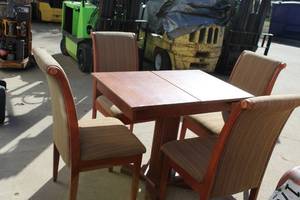 solid wood dining table set with four upholstered chairs. Storage space under each chair