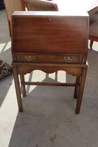 lot 12 image: drop front desk. It features a drop-down top for a writing surface, interior cubbies, and a single drawer below,