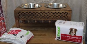 lot 101 image: PetShoppe heavy duty training pads and a wooden elevated pet feeder.