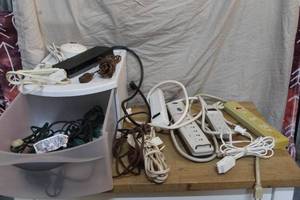 lot 130 image: Tote drawer full of extension cords and surge protectors