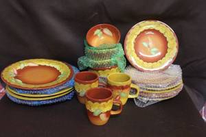 lot 192 image: collection of stoneware dinnerware is likely part of the Santa Fe collection by Laurie Gates.one plate has a few chips on the bottom