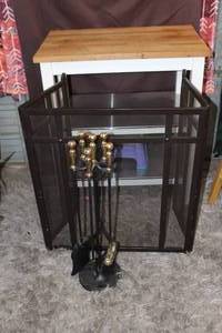 lot 322 image: black wrought iron indoor firewood rack with an integrated four-piece tool set.