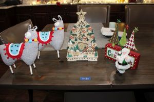 lot 82 image: Christmas dcor llamas, wood carved tree, green Santa
