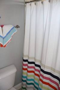 lot 138 image: Bathroom contents See all photos,  bathroom with colorful striped curtain