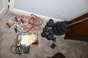 lot 124 image: Exercise lot Vinyl weight plates and bar, Kettle bells, DVDs, bands, see all photos. Generous amount of weights - VERY HEAVY