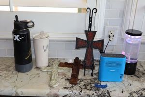 lot 55 image: Decorative crosses, Bose portable speaker, travel mugs, and Jellyfish lamp