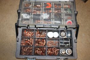 lot 247 image: Husky parts box with LOTS of copper fittings