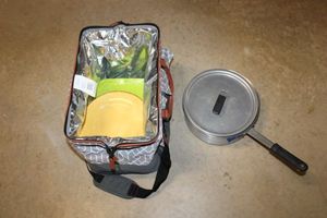 lot 213 image: Picnic bag with plastic plates, storage container and Vollrath pan