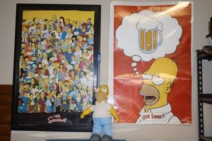 lot 212 image: The Simpsons doll and posters