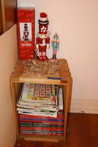 lot 21 image: Crate with Christmas books, clear grape cluster bowls, and nutcrackers