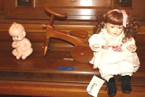 lot 27 image: Vintage porcelain doll named Britney, wooden tricycle, and vintage Kewpie doll