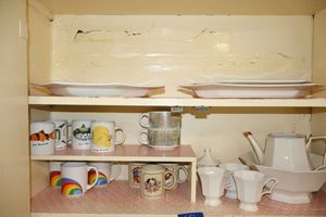 lot 251 image: White geometric dishes and coffee mugs
