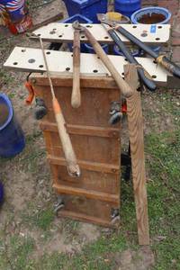 lot 360 image: Vintage creeper, yard tools, work bench, metal stand and vintage swings