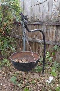 lot 376 image: Iron hanging cauldron (may be based in cement - please preview)