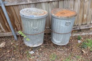 lot 375 image: Metal trash cans with rebar stand