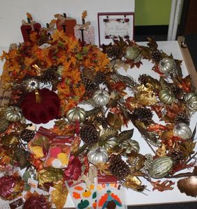 lot 43 image: Fall Decorations, including garland, ceramic leaf dishes, ceramic burgundy pumpkin, fallpumpkin garland, and pictures