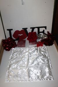 lot 55 image: Wooden Love sign, Red Rose Petals, Two White Satin Pillowcases. Heart Battery Powered Lights, Hearts with mirror tiles, red shimmer decorative pieces and Red Roses