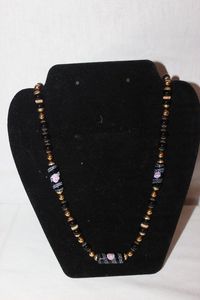 lot 166 image: Jewelry Vintage Venetian Murano wedding cake glass bead in a black and gold colorway with a pink rose decoration.