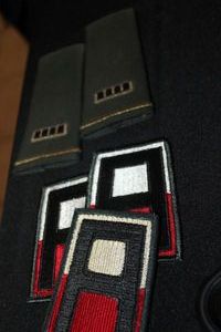 lot 186 image: Three 1st Army Class A Shoulder Patches and a pair of Army Chief Warrant Officer 4 Shoulder Board&nbsp