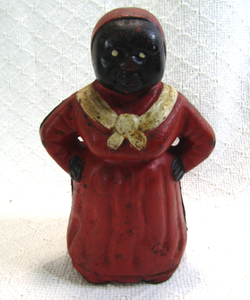 lot 570 image: Antique Aunt Jamima cast iron coin bank