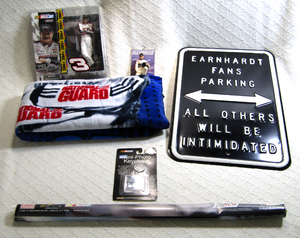 lot 598 image: NASCAR Dale Earnhardt collectibles, metal sign, sealed poster, beach towel, keychain, ornament and sealed action figure