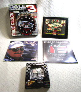 lot 600 image: NASCAR Dale Earnhardt collectibles, wall clock, sealed calenders, light switch cover, and Circle track placard