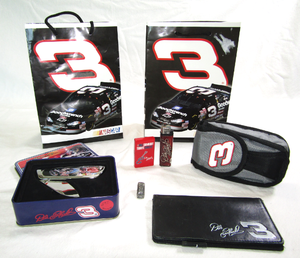 lot 605 image: NASCAR Dale Earnhardt collectibles, phone case, pocket knife, wallet, lighters, and gift bags