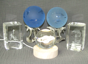 lot 614 image: Glass art, Dolphin ocean blue orbs with display stands, Dolphin laser etched glass blocks, Glass orb Saturn with illimunated display stand