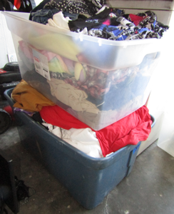 lot 566 image: Two storage totes packed full of assorted clothing
