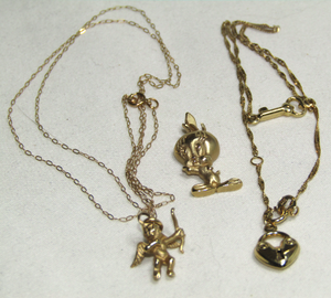 lot 643 image: 14K Gold jewelry (marked 14k), Tweety bird pendant, angel pendant and necklace, Heart lock with key pendants and necklace