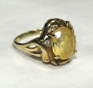 lot 650 image: 10k Gold (marked 10k) ring with yellow sapphire and diamond chip gem stones