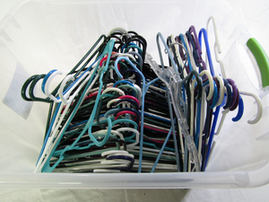lot 702 image: Sterilite tote with lid full of plastic hangers