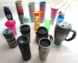 lot 575 image: Assorted coffee travel cups including Starbucks and a Mercedes Benz cup