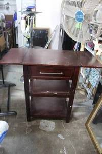 lot 12 image: dark wood folding kitchen cart  going to need some tlc the bottom of the drawer needs fixed but have it