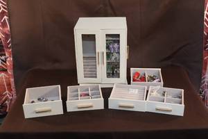 lot 27 image: Jewelry box with jewelry took the drawers out so you could see what was in them